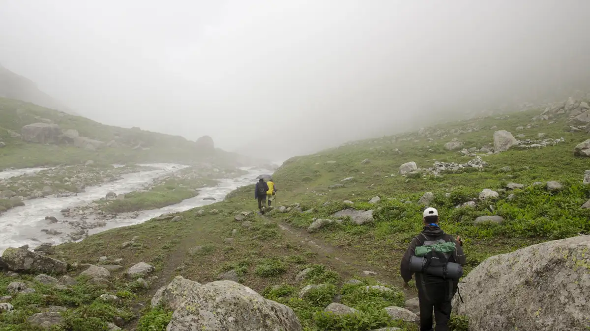 Where the road is taking me... Trekkers walking into fog on Deo Tibba trail Himachal Pradesh